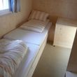 2nd bedroom with 2 single beds and storage