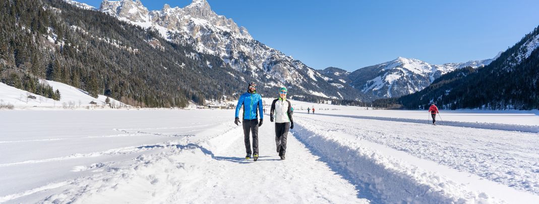 Im Tannheimer Tal erwarten dich winterliche Wanderfreuden zwischen verschneiten Gipfeln und gefrorenen Bergseen.