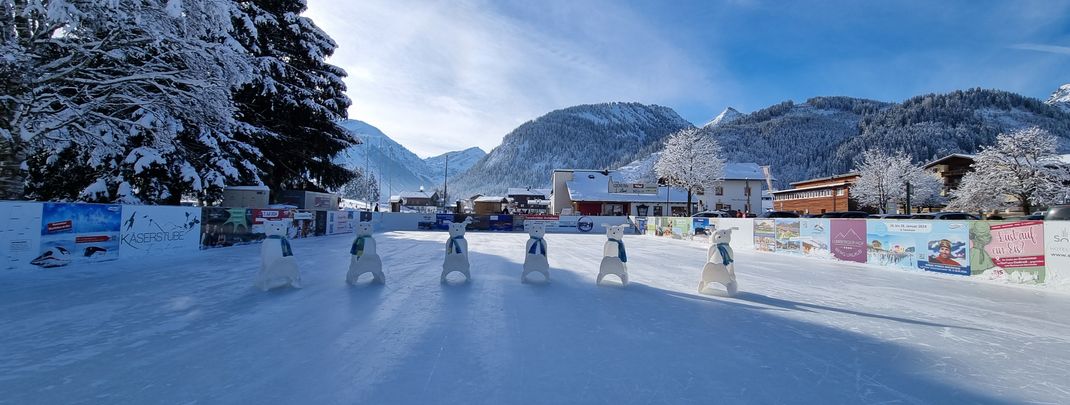 Eislaufspaß im Herzen des Tannheimer Tals – auf dem idyllischen Eislaufplatz gleiten Groß und Klein vor beeindruckender Bergkulisse übers Eis.