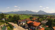 Archived webcam image showing Hopfensee - View to Reutte-Hahnenkamm ski resort on 30 Jul 2026 at 14:09