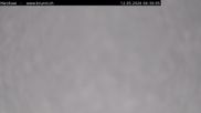 Archived webcam image showing Engelberg: Lake Härzlisee & mountain restaurant Kräuterhütte on 12 May 2026 at 06:53