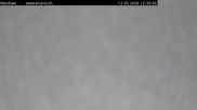 Archived webcam image showing Engelberg: Lake Härzlisee & mountain restaurant Kräuterhütte on 12 May 2026 at 12:53