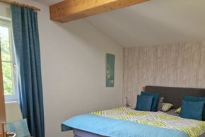 Schlafzimmer Südbalkonwohnung Ausblick Bergwelt Hahnenkamm