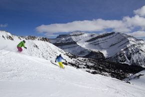 Skiing with a glorious view of the mountains and perfect snow conditions.