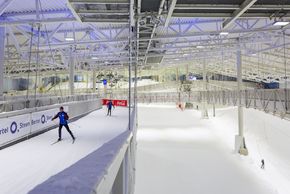 A cross-country ski track runs above the alpine slope.