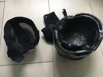 Remove the helmet's padding and wash it by hand.