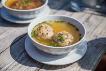 A hearty bacon dumpling soup at the mountain hut delights every palate.