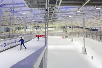 A cross-country ski track runs above the alpine slope.
